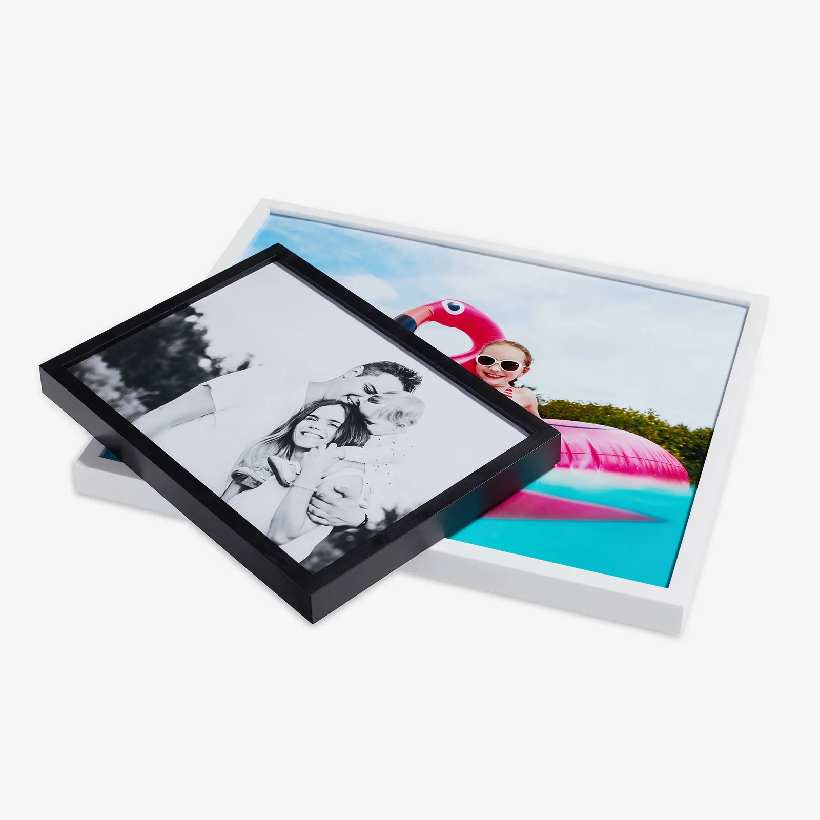 A black and a white frame, each holding a photo